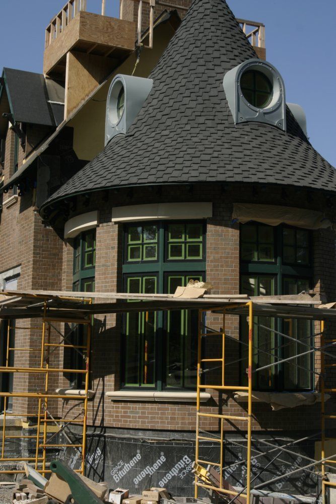 A large brick building under construction with scaffolding around it