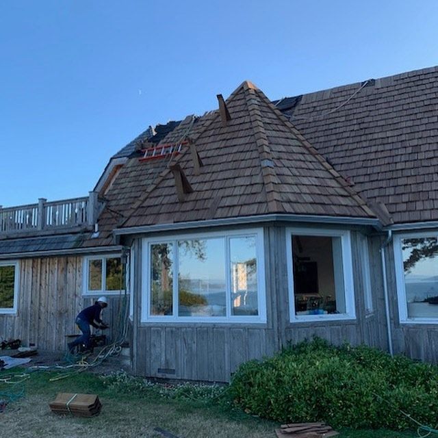 A man is working on the roof of a house